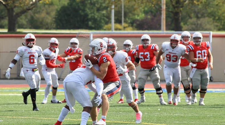 Dayton's Sam Bubonics hangs on to a catch after a hard hit by Marist in the fourth quarter on Saturday, Oct. 16, 2021, at Welcome Stadium. David Jablonski/Staff
