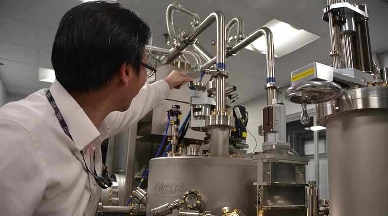 Dr. Shin Mou, Air Force Research Laboratory materials researcher, shows off the laboratory’s new Molecular Beam Epitaxy chamber, a highly specialized piece of equipment that enables the growth of semiconducting materials for a new breed of lighter, smaller, more agile electronics. (U.S. Air Force photo/Adrienne Kreighbaum)