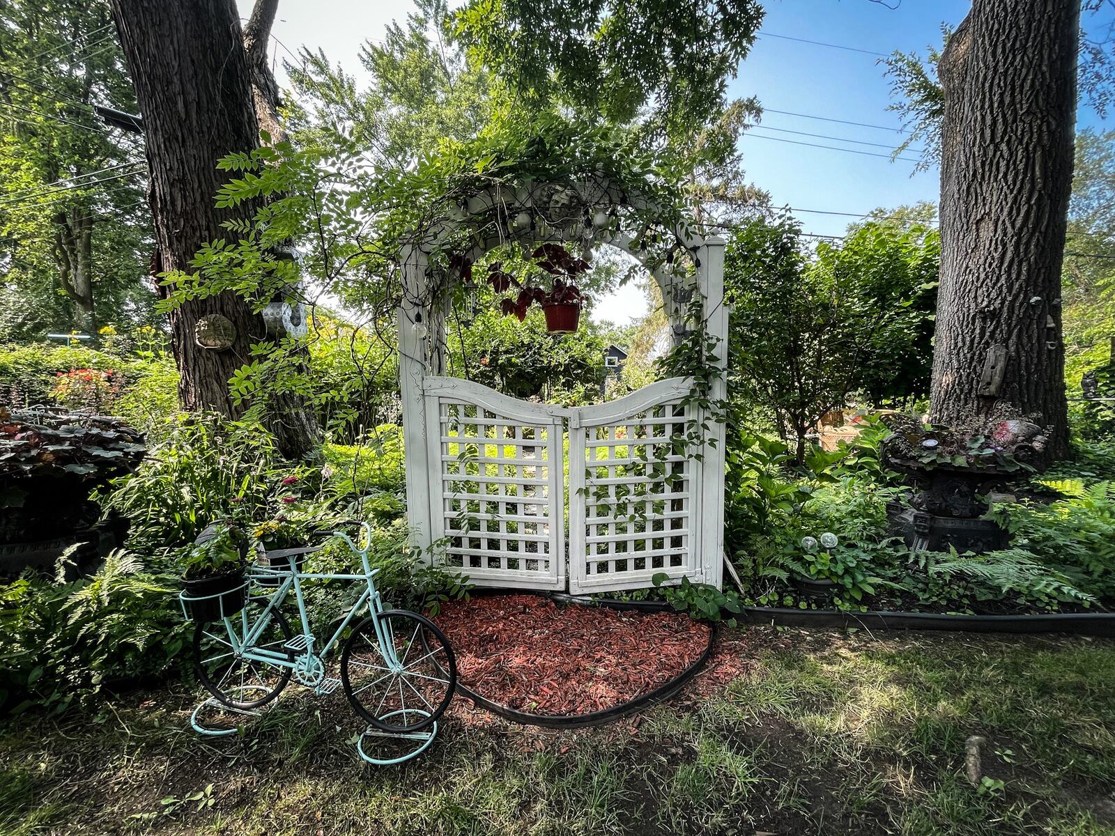 Jessie Bange's family found this 100-year-old garden gate on the side of a road. The family dismantled it and installed it in Jessie's garden. JIM NOELKER/STAFF