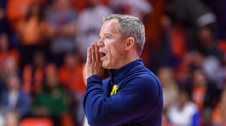 Michigan head coach Dusty May shouts to his team during an NCAA college basketball game against Illinois, Friday, Feb. 27, 2026, in Champaign, Ill. (AP Photo/Craig Pessman)