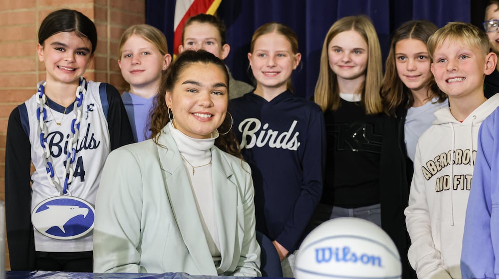 Maddy Westbeld (bottom left), a Fairmont graduate who plays professional basketball for Chicago Sky, poses for a photo with students after talking at an afternoon assembly at J.E. Prass Elementary School in Kettering on Friday, Dec. 12. BRYANT BILLING/STAFF