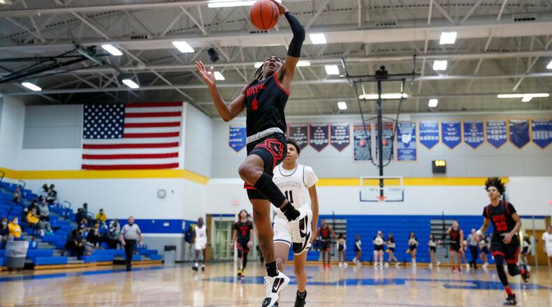 Cutline: Wayne High School senior Prophet Johnson leaps for a dunk during their game at Springfield High School on Tuesday night in Springfield. The Warriors won 97-82. Michael Cooper/CONTRIBUTED