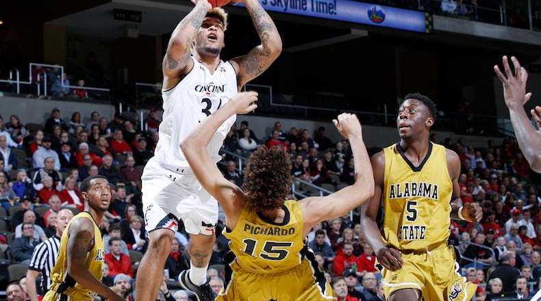 HIGHLAND HEIGHTS, KY - NOVEMBER 27: Jarron Cumberland #34 of the Cincinnati Bearcats drives to the basket against Fausto Pichardo #15 and Tobi Ewuosho #5 of the Alabama State Hornets in the first half of a game at BB&T Arena on November 27, 2017 in Highland Heights, Kentucky. Cincinnati won 83-51. (Photo by Joe Robbins/Getty Images)