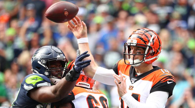 SEATTLE, WASHINGTON - SEPTEMBER 08: Andy Dalton #14 of the Cincinnati Bengals throws the ball against Rasheem Green #98 of the Seattle Seahawks in the second quarter during their game at CenturyLink Field on September 08, 2019 in Seattle, Washington. (Photo by Abbie Parr/Getty Images)