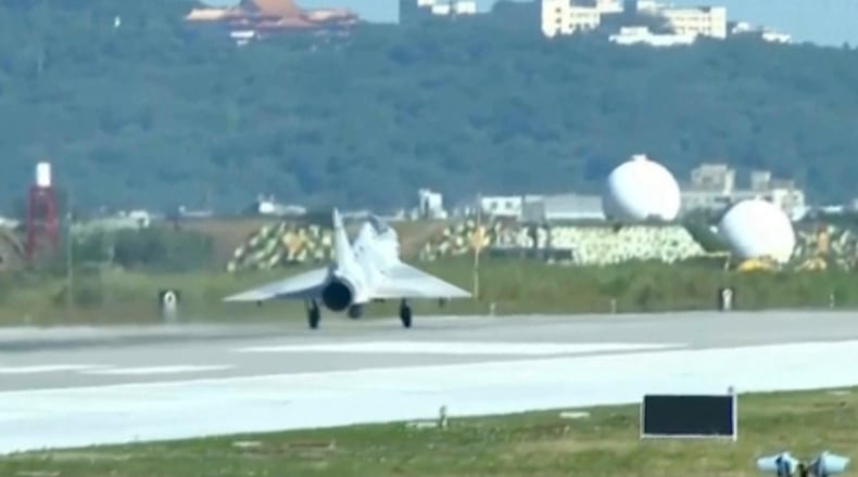 In this image taken off video, a Taiwan fighter jet lands at the Hsinchu Airbase in Taiwan on Monday, Dec. 29, 2025. (AP Photo/Wu Taijing)