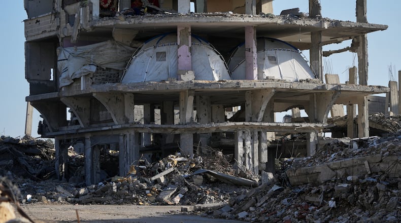 Tents are set up inside a gutted apartment building in Khan Younis, in the southern Gaza Strip, Saturday, Nov. 15, 2025. (AP Photo/Abdel Kareem Hana)