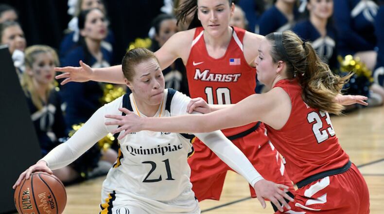 Quinnipiac forward Jen Fay (21) moves the ball against Marist's Maura Fitzpatrick (10) and Rebekah Hand (23) during the second half of an NCAA college basketball game in the championship of the Metro Atlantic Athletic Conference tournament Monday, March 5, 2018, in Albany, N.Y. Quinnipiac won the game 67-58. (AP Photo/Hans Pennink)