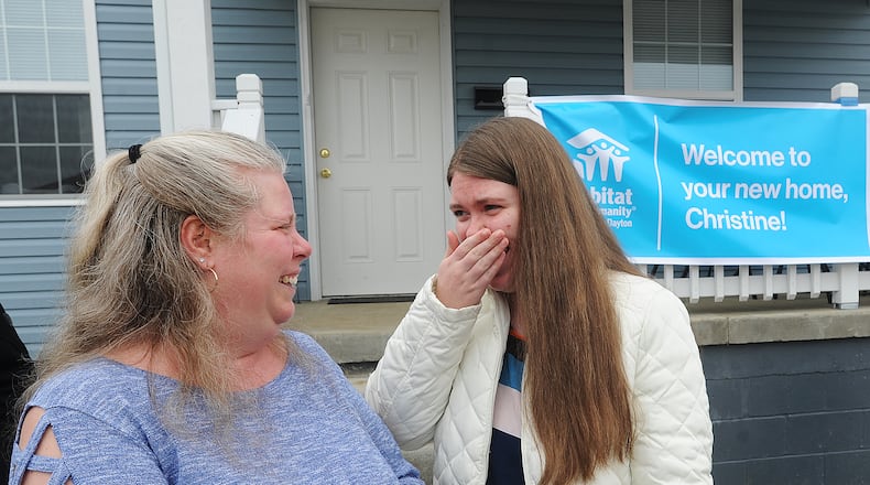 Christine Creager, left and her daughter Kansas, express their emotions after moving back into their home on Macready Ave. that was destroyed by the 2019 Memorial Day tornados.
Habitat for Humanity and the Miami Valley Long-Term Recovery Operations Group welcome the Creagers home Tuesday, March 16, 2021. MARSHALL GORBY/STAFF