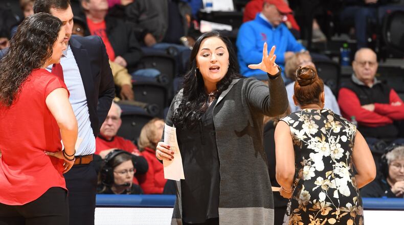 Dayton assistant coach Calamity McEntire talks to head coach Shauna Green and assistant Ryan Gensler during Friday afternoon’s game vs. Buffalo at UD Arena. Erik Schelkun/CONTRIBUTED