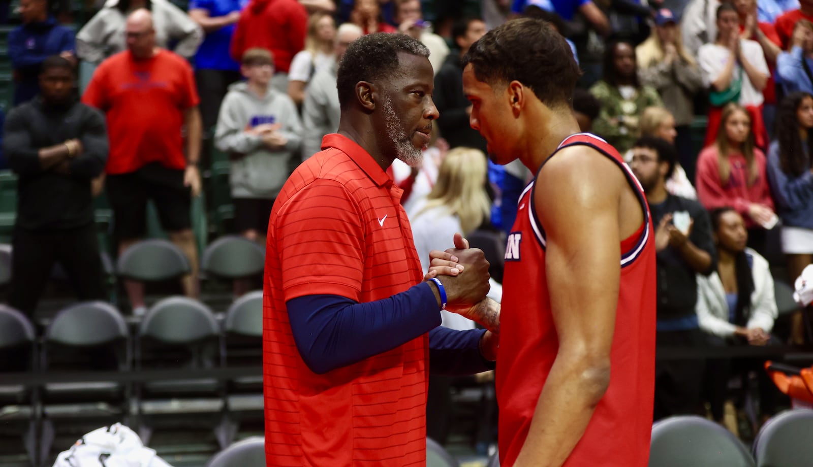Dayton's Anthony Grant shakes hands with De'Shayne Montgomery after a loss to Brigham Young on Friday, Nov. 28, 2025, at the State Farm Field House in Kissimmee, Fla. David Jablonski/Staff