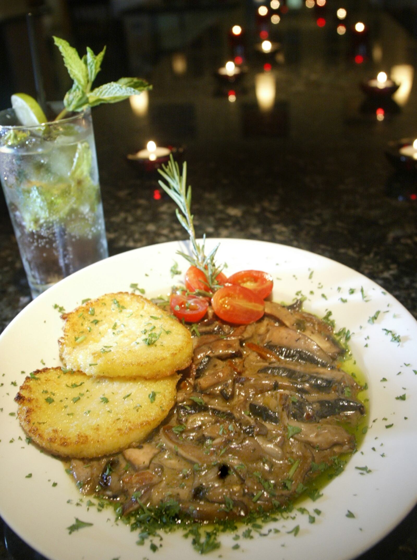 Figlio's Wild Mushroom with Polenta, their most popular starter, with wild mushrooms in Marsala cream sauce served with two lightly sauteed polenta rounds.