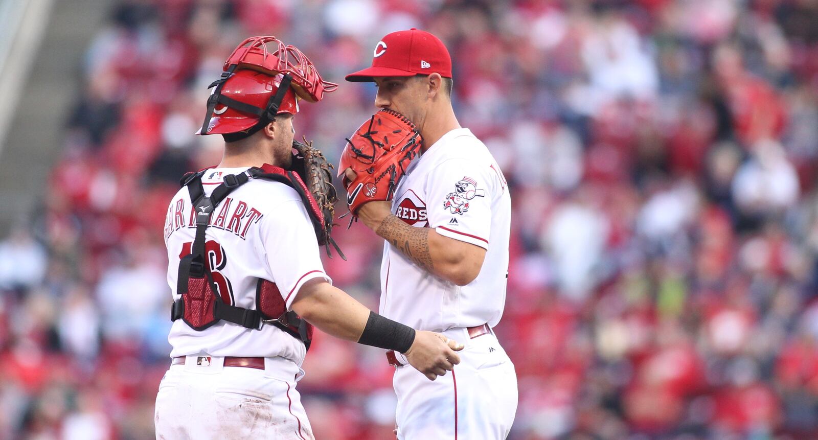 Reds catcher Tucker Barnhart talks to reliever Michael Lorenzen during a game against the Phillies on Monday, April 3, 2017, at Great American Ball Park in Cincinnati. David Jablonski/Staff