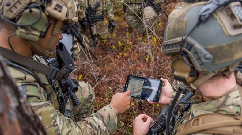 Members of the 6th Special Operations Squadron use a tablet to upload coordinates during an exercise showcasing the capabilities of the Advanced Battle Management System at Duke Field, Fla. in December 2019. During the first demonstration of the ABMS, operators across the Air Force, Army, Navy and industry tested multiple real-time data sharing tools and technology in a homeland defense-based scenario. (U.S. Air Force photo by Tech. Sgt. Joshua J. Garcia)