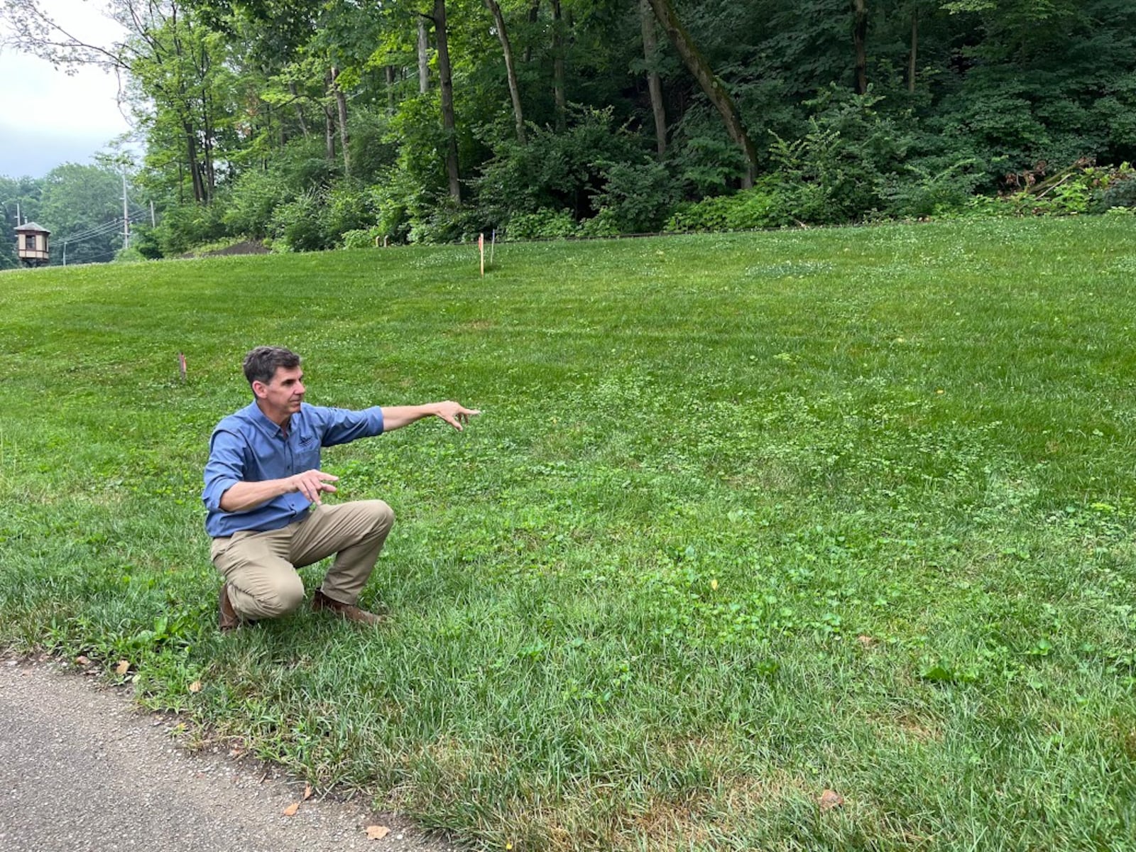 Brady Kress, president and CEO of Dayton History, gestures over the area where he plans to have a "performance barn" built at Carillon Park, behind Carillon Brewing Co. THOMAS GNAU/STAFF