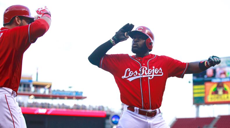 The Reds' Brandon Phillips, right, and Joey Votto celebrate after a two-run home run by Phillips in the second inning against the Brewers on Thursday, May 5, 2016, at Great American Ball Park in Cincinnati. David Jablonski/Staff