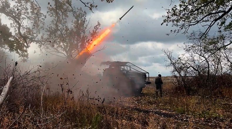 In this image made from video provided by the Russian Defense Ministry Press Service on Friday, Oct. 31, 2025, a Russian "Grad" self-propelled 122 mm multiple rocket launcher fires towards Ukrainian positions on an undisclosed location in Ukraine. (Russian Defense Ministry Press Service via AP)
