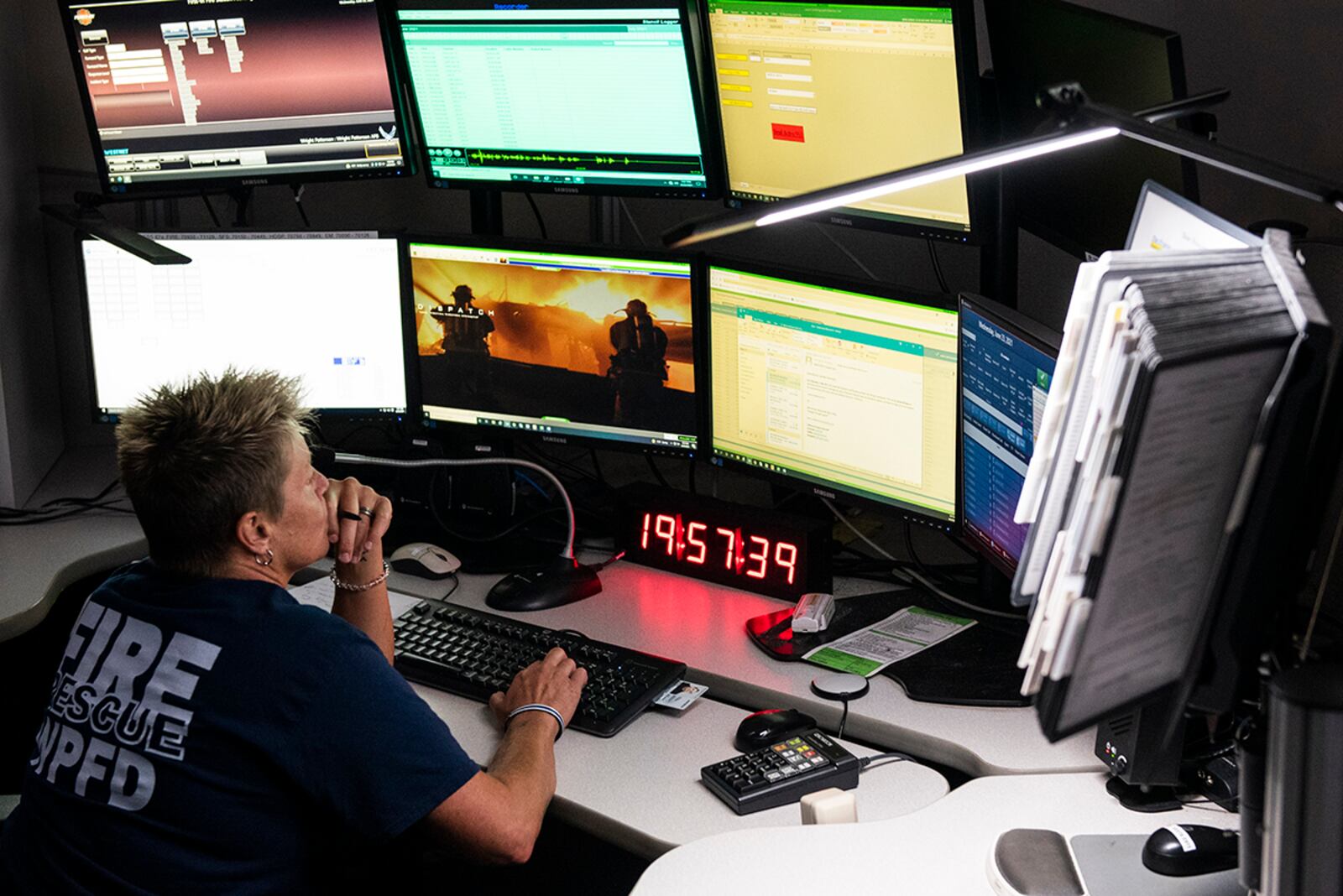 Marian Nevin, 788th Civil Engineer Fire Department dispatcher, works at her station inside the control and dispatch room of Station 1 June 23 at Wright-Patterson Air Force Base. The fire department is on call 24/7 all year and capable of responding anywhere on base within 5 minutes when a call for help comes in. U.S. AIR FORCE PHOTO/WESLEY FARNSWORTH