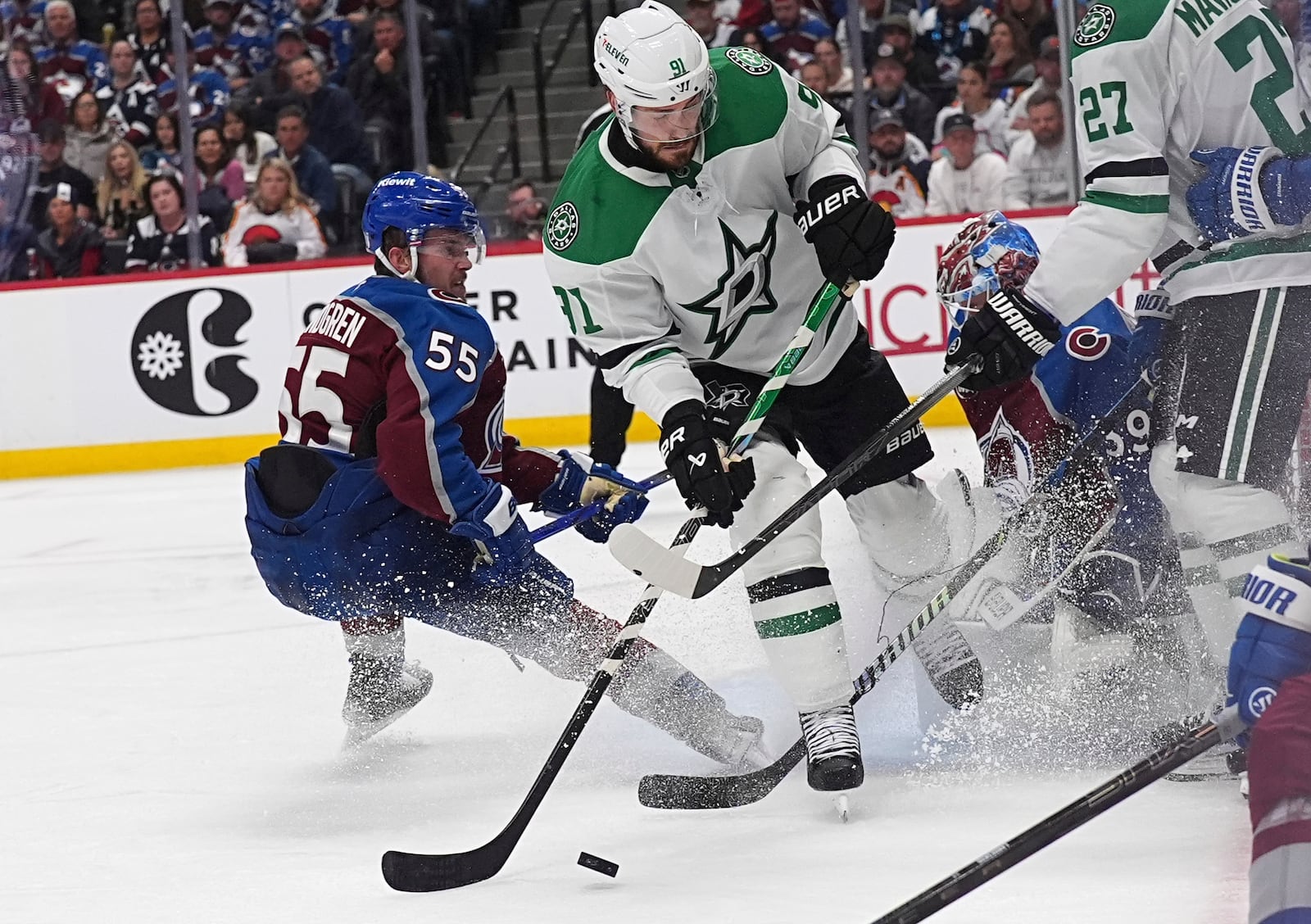 Dallas Stars center Tyler Seguin, center, shoots against Colorado Avalanche goaltender Mackenzie Blackwood, third from left, as Avalanche defenseman Ryan Lindgren (55) covers in the second period of Game 6 of an NHL hockey first-round playoff series Thursday, May 1, 2025, in Denver. (AP Photo/David Zalubowski)