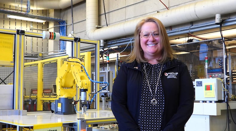 Dawn Warner, apprenticeship project manager at Sinclair Community College, is in the robotics laboratory at Sinclair where many of the apprentices take classes..
