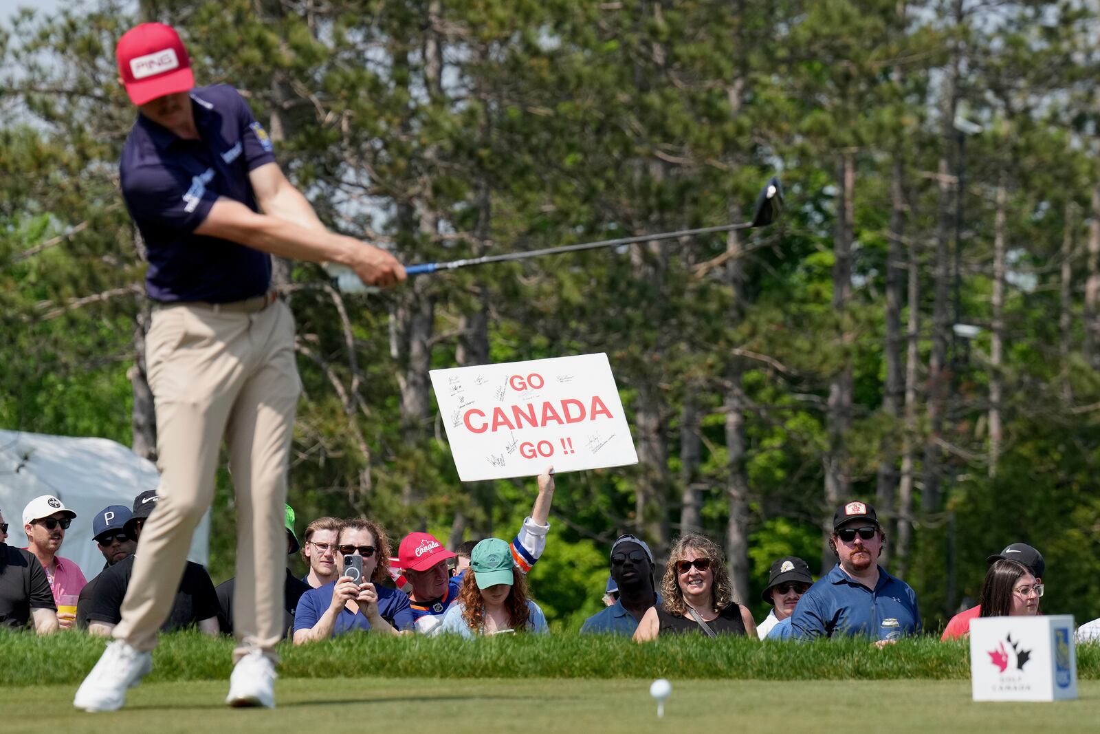 Canadian fans cheer on their national players as Mackenzie Hughes tees off at the 17th hole during the third round of the Canadian Open golf tournament in Caledon, Ontario, Saturday, June 7, 2025. (Nathan Denette/The Canadian Press via AP)
