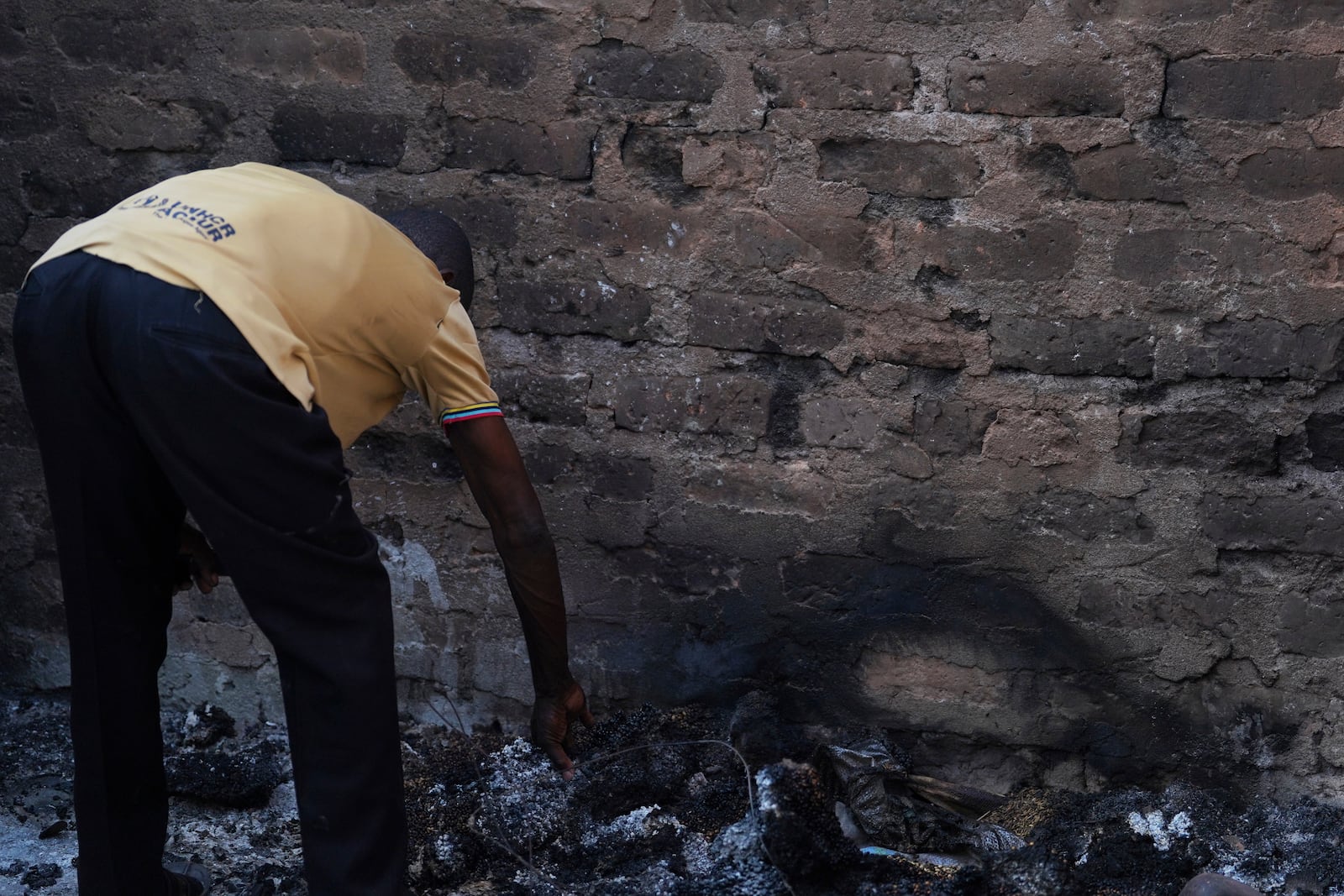 A man looks at a burned house following an attack by gunmen in Yelewata community north-central Nigeria, Monday, June 16, 2025. (AP Photo)