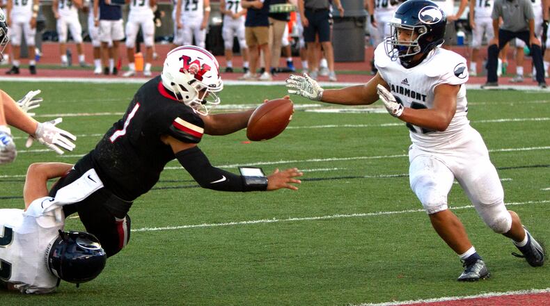 Wayne quarterback Cam Fancher scores one of his three touchdowns during the Warriors' 31-24 victory over Fairmont on Friday night. Jeff Gilbert/CONTRIBUTED