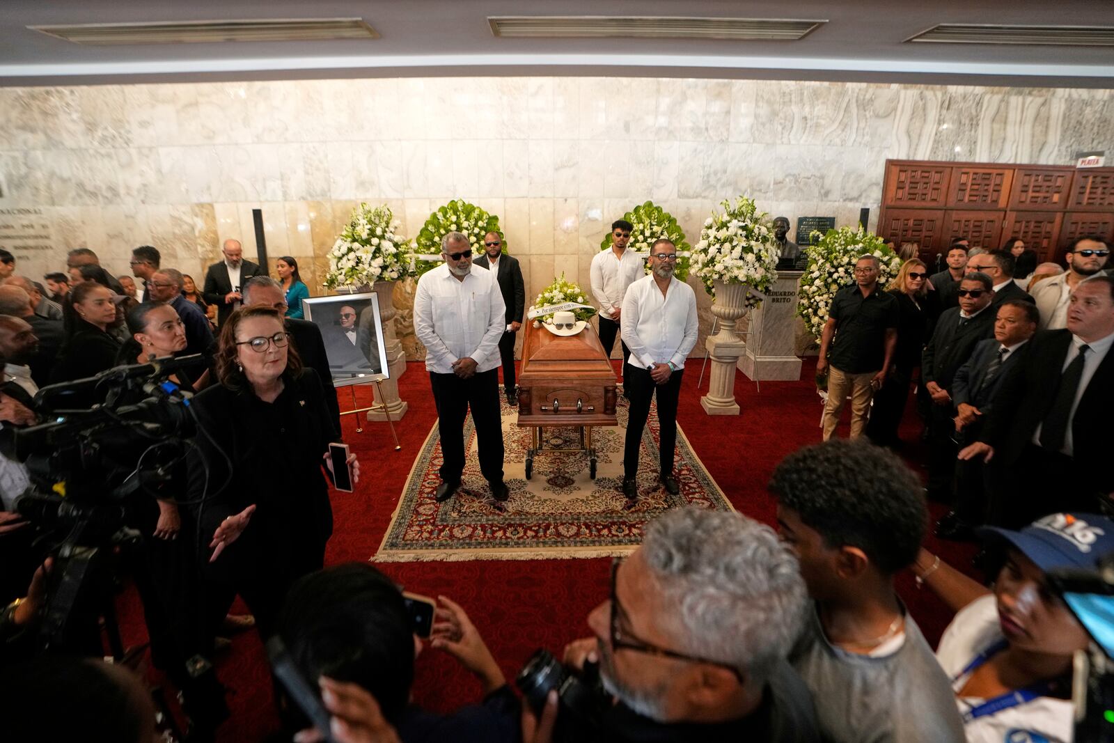 Mourners attend a memorial for Rubby Perez, the merengue singer who was performing at the Jet Set nightclub when its roof collapsed, killing more than 200 people, at the National Theater in Santo Domingo, Dominican Republic, Thursday, April 10, 2025. (AP Photo/Matias Delacroix)