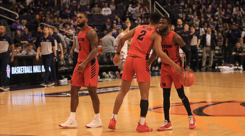 Dayton players (left to right) Trey Landers, Ibi Watson and Jalen Crutcher react after a victory against Saint Mary’s on Sunday, Dec. 8, 2019, at Talking Stick Resort Arena in Phoenix, Ariz. David Jablonski/Staff