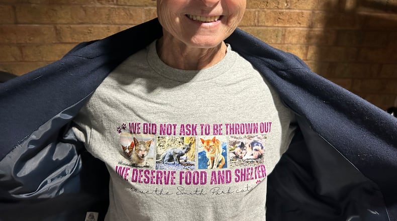 Cinda Lee, one of those who opposes how the city of Middletown is handling the overpopulation of cats in Smith Park, shows off the T-shirt that she and other animal advocates wore to Tuesday night's city council meeting. RICK McCRABB/CONTRIBUTOR