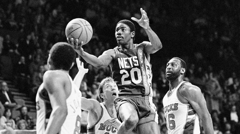 FILE - New Jersey Nets; Michael Ray Richardson (20) drives to the basket past Milwaukee Bucks' Mike Dunleavy (10) and Bob Lanier (16) during the first quarter of an NBA basketball playoff game, May 8, 1984, Milwaukee. (AP Photo/Tom Lynn, FIle)