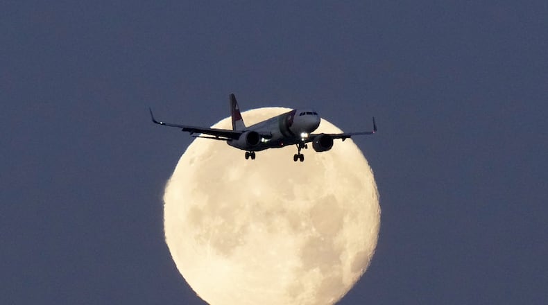 FILE - A TAP Air Portugal Airbus A320 is silhouetted against the setting moon while approaching for landing in Lisbon, Portugal, June 23, 2024. (AP Photo/Armando Franca, File)