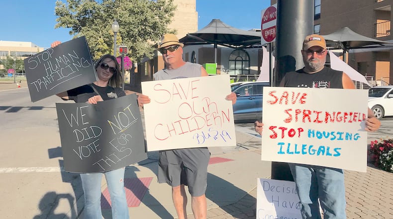 Pictured (L to R) are Melissa and Jay Durst and a man who wished not to be identified who joined other Springfield residents expressing frustration following a fatal school bus accident that resulted in vehicular homicide charges against Haitian immigrant Hemanio Joseph. Citizens demanded action from city officials, who say they have a limited role in addressing immigrant issues. CONTRIBUTED BY VICKY FORREST