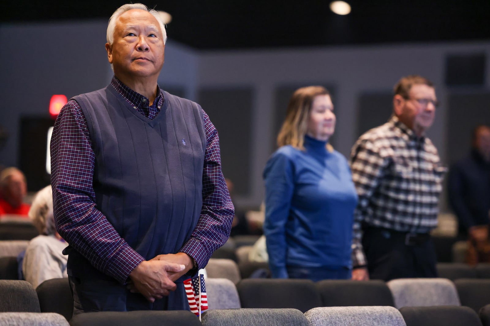 Retired Air Force Major Walter Chin (left) stands while Air Force veterans were being recognized during a Veterans Day ceremony on Tuesday, Nov. 11 at Be Hope Church in Beavercreek. Chin and his wife Denise both served in the Air Force, including during the Dayton Peace Accords. BRYANT BILLING/STAFF
