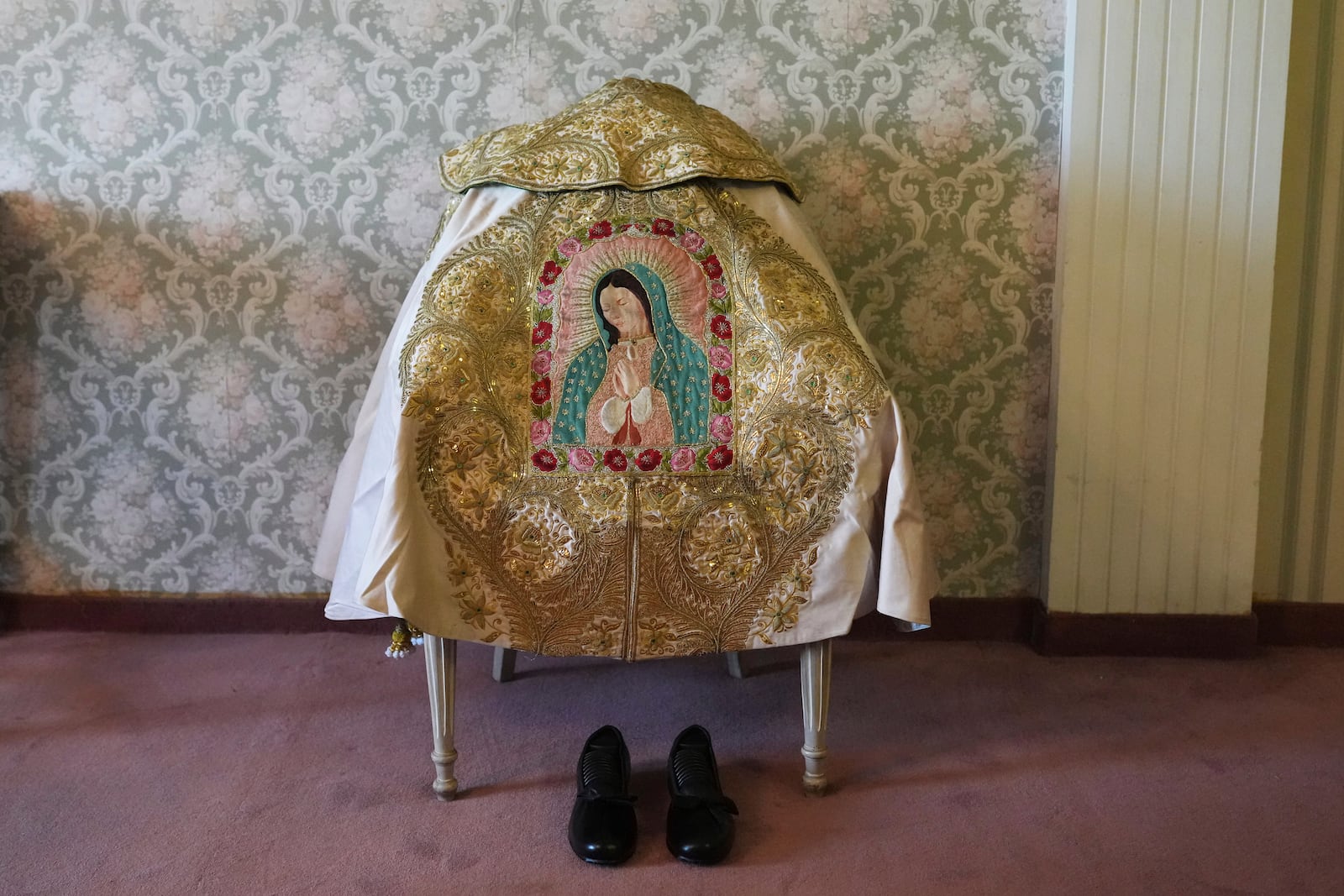 An embroidered image of the Virgin of Guadalupe decorates Mexican bullfighter Diego Silveti's capote, or bullfighter's cape, in a hotel room in Aguascalientes, Mexico, Sunday, April 27, 2025. (AP Photo/Eduardo Verdugo)