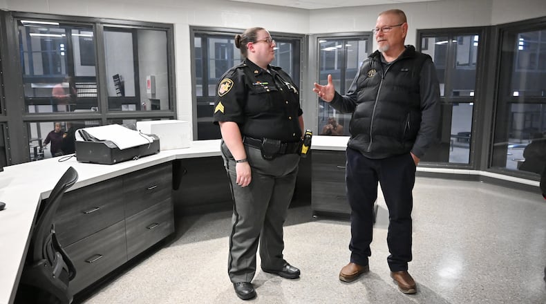 Greene County Sheriff's Office Sgt. Desire Henson (left) talks to Greene County Coroner's Office chief investigator Warren Hensley during tours of the new Greene County Jail and Gene Fischer Justice Center on Wednesday, Nov. 19. Henson, who is a retired deputy, was one of many who toured the jail after a ribbon cutting ceremony. Inmates will be transferred to the jail in mid-December. BRYANT BILLING/STAFF
