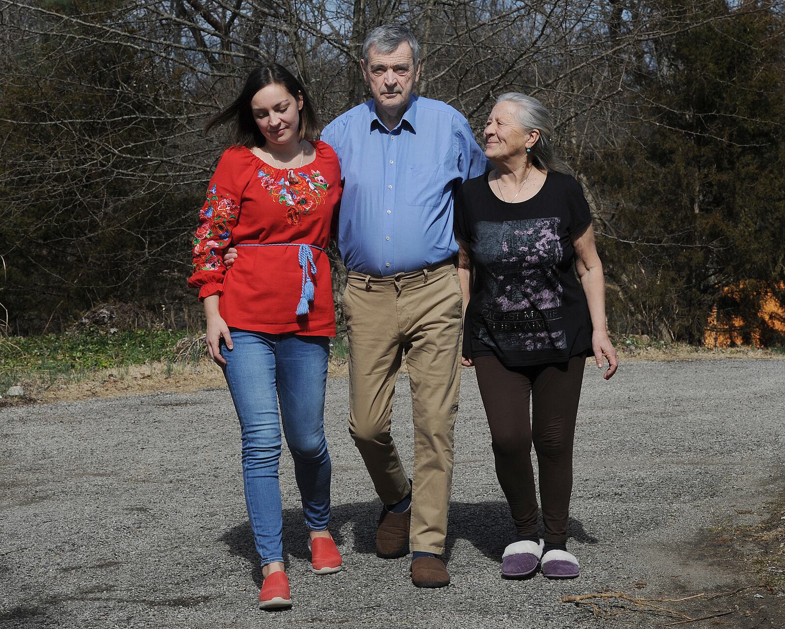 Oleg Gubernator embraces his wife, Larysa and daughter, Anastasia Nagle, left, after arriving in the Dayton area last week. Oleg and Larysa Gubernator are from Ukraine and saw missles in the air during the Russian invansion. MARSHALL GORBY\STAFF