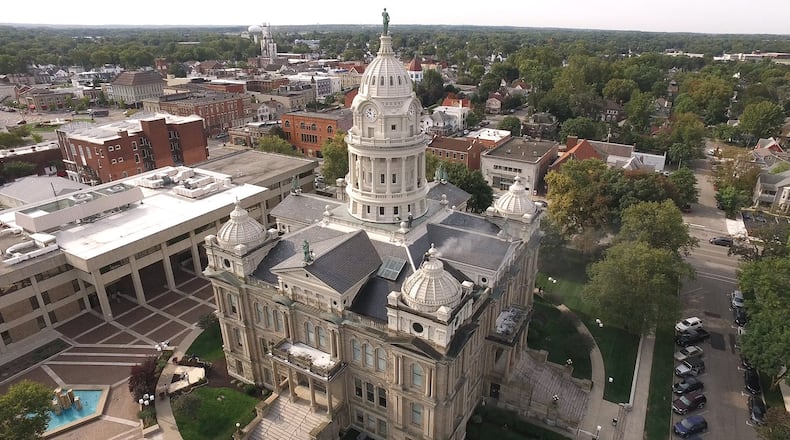 The Miami County Courthouse in Troy seen from the air as contractors prepare to paint the corner domes.   TY GREENLEES / STAFF