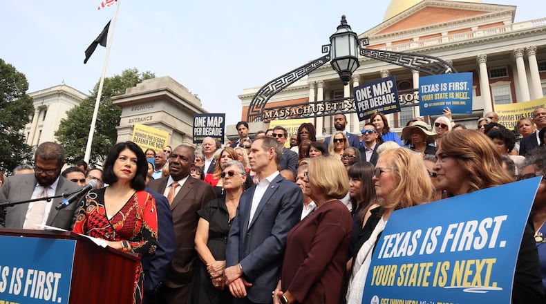Texas State Senator Carol Alvarado, a Democrat, speaks in a crowd of other Democratic state lawmakers outside the Massachusetts State House on Wednesday, Aug. 6, 2025 in Boston. (AP Photo/Leah Willingham)