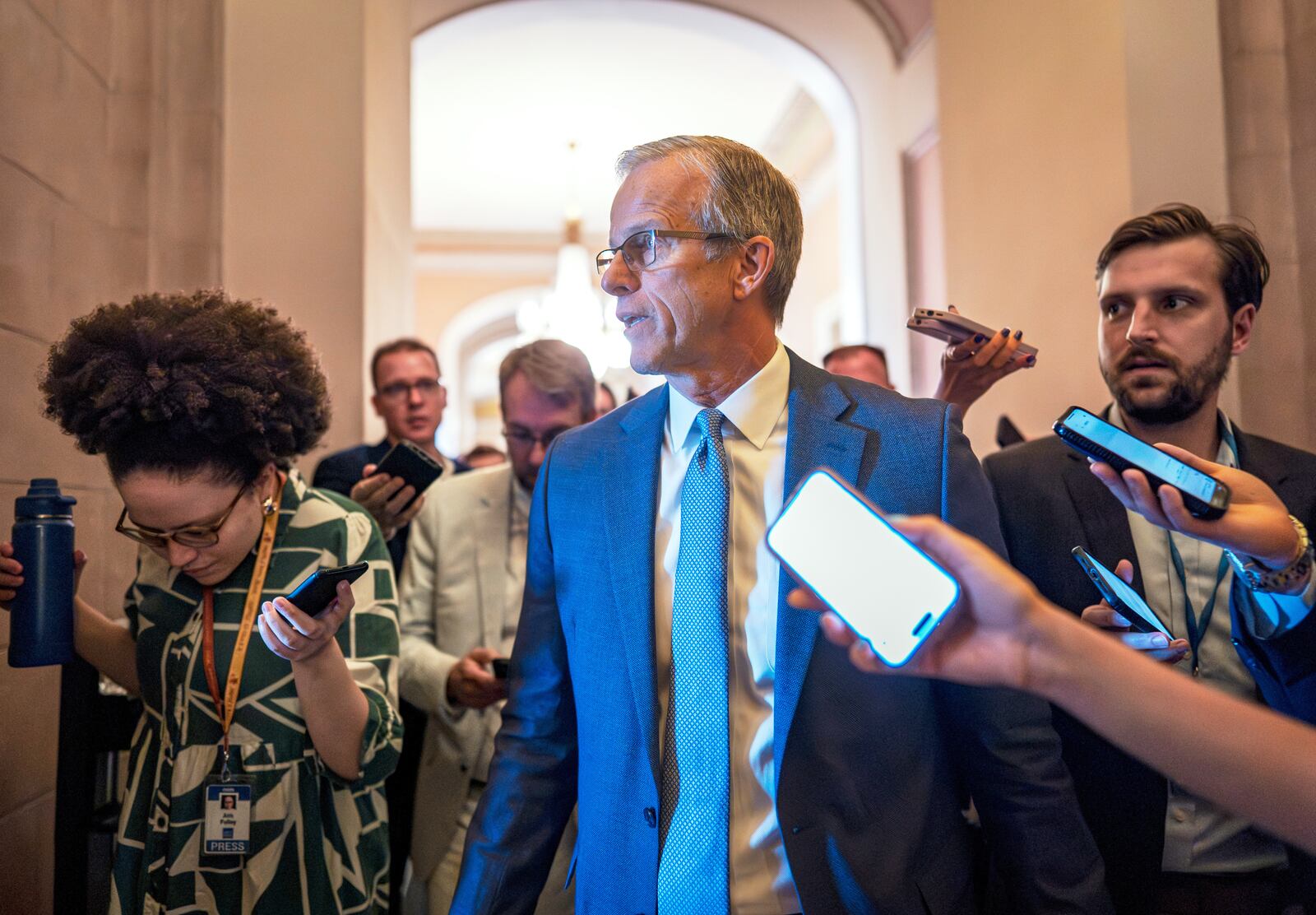 Senate Majority Leader John Thune, R-S.D., rushes from the chamber to his office as he struggles with Republicans opposed to President Donald Trump's signature bill of big tax breaks and spending cuts, at the Capitol in Washington, Tuesday, July 1, 2025. (AP Photo/J. Scott Applewhite)