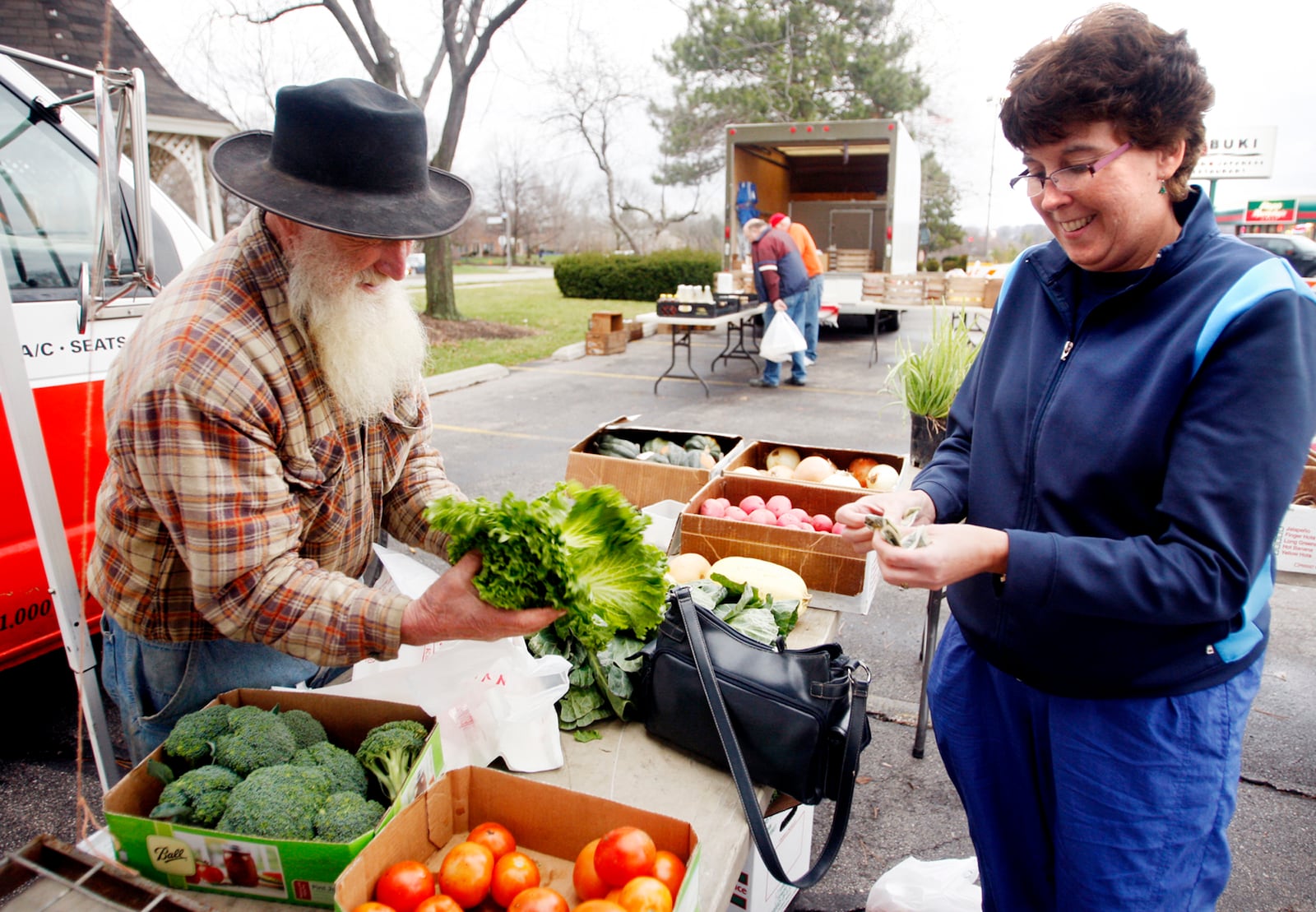 Susan Schmellenkamp talks with farmer Russell Garber of Garber Farms as she purchases vegetables at the Centerville Farmer's Market in 2011. DAYTON DAILY NEWS ARCHIVES