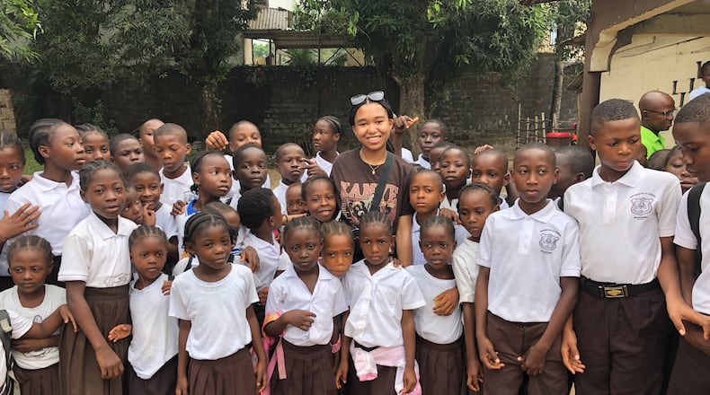 Brooke Gates, center, with students in Liberia. CONTRIBUTED