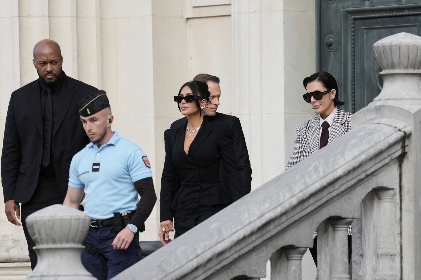 Kim Kardashian, center, accompanied by her mother Kris Jenner, right, leaves the justice palace after testifying, regarding a robbery of millions of dollars in jewels from her Paris hotel room in 2016, in Paris, Tuesday, May 13, 2025. (AP Photo/Aurelien Morissard)