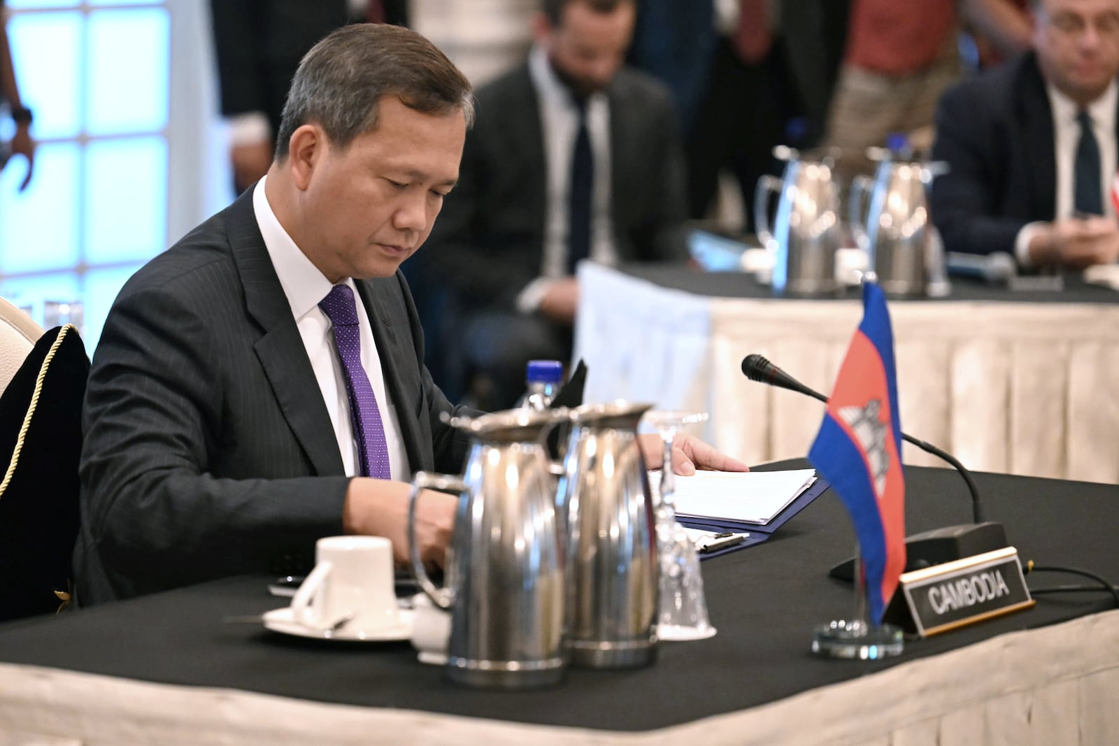 Cambodia's Prime Minister Hun Manet, center, looks on during talks with Thailand's acting Prime Minister Phumtham Wechayachai, mediated by Malaysia's Prime Minister Anwar Ibrahim, on a possible ceasefire between Thailand and Cambodia in Putrajaya Monday, July 28, 2025.(Mohd Rasfan/Pool Photo via AP)