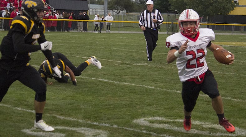 Tippecanoe running back Clay Barhorst turns upfield against Shawnee’s Cyres Cooper in the first half of Friday’s game at Shawnee. JEFF GILBERT / CONTRIBUTED