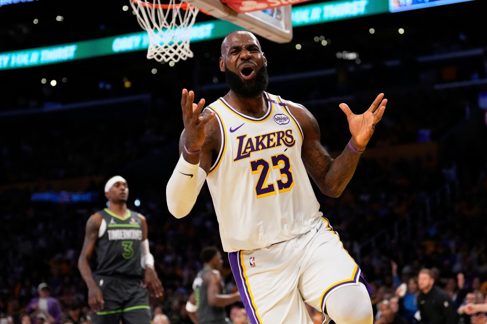 Los Angeles Lakers forward LeBron James, right, reacts after missing a pass during the first half in Game 1 of an NBA first-round playoff series against the Minnesota Timberwolves Saturday, April 19, 2025, in Los Angeles. (AP Photo/Mark J. Terrill)