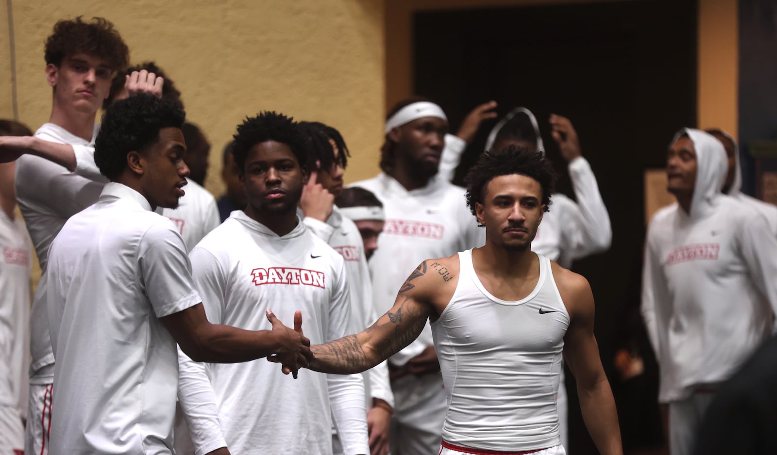 Dayton players, including Javon Bennett, front right, wait to the take the court before a game against Georgetown on Thursday, Nov. 27, 2025, at the State Farm Field House in Kissimmee, Fla. David Jablonski/Staff