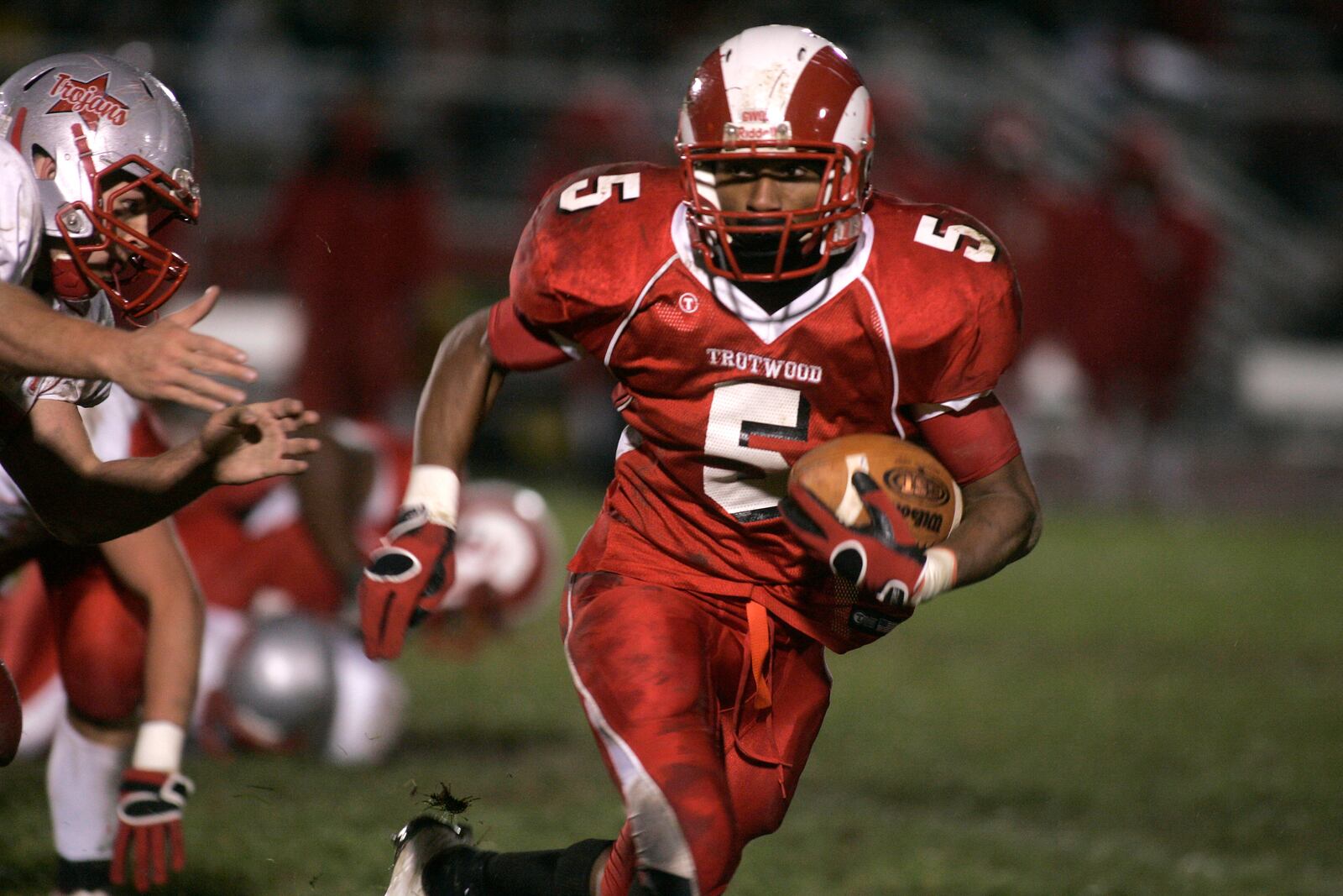 Trotwood-Madison High School running back Antwan Gilbert (5) makes his way through Troy’s defense Friday night at Trotwood-Madison. Gilbert carried the ball 35 times in the Rams’ GWOC win.