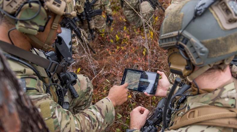 Members of the 6th Special Operations Squadron use a tablet to upload coordinates during an exercise showcasing the capabilities of the Advanced Battle Management System at Duke Field, Fla., Dec. 17, 2019. During the first demonstration of the ABMS, operators across the Air Force, Army, Navy and industry tested multiple real-time data sharing tools and technology in a homeland defense-based scenario enacted by U.S. Northern Command and enabled by Air Force senior leaders. The collection of networked systems and immediately available information is critical to enabling joint service operations across all domains. (U.S. Air Force photo by Tech. Sgt. Joshua J. Garcia)