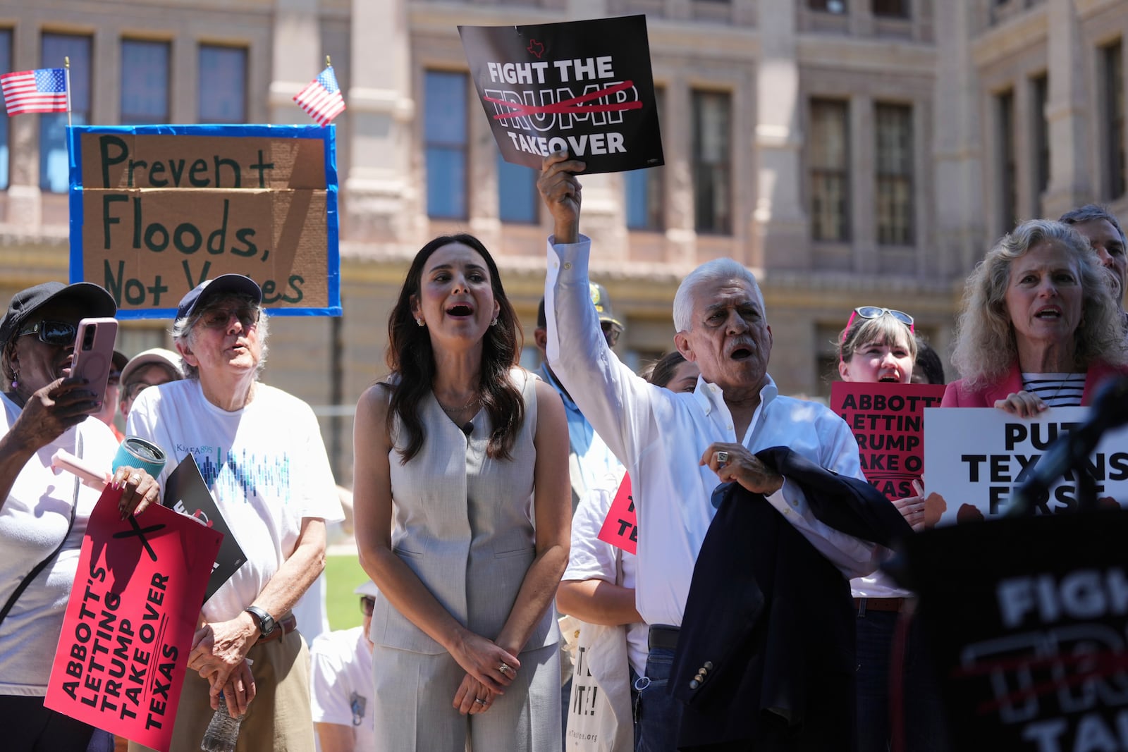 Texas state Rep Gina Hinojosa, center, joins others at a rally to protest against redistricting hearings at the Texas Capitol, Thursday, July 24, 2025, in Austin, Texas. (AP Photo/Eric Gay)