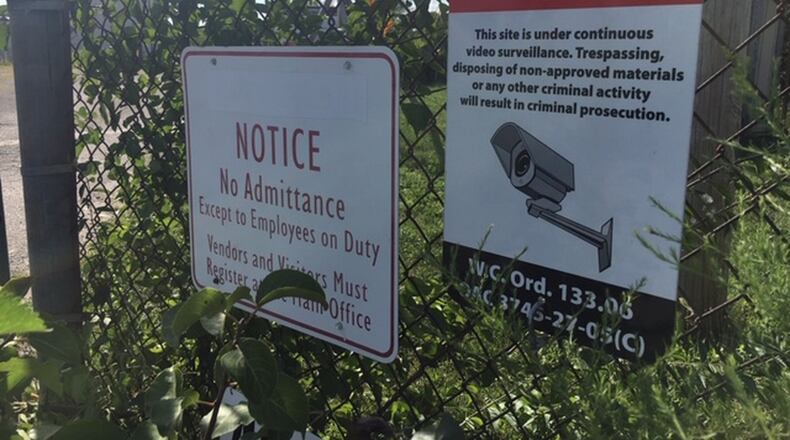 After several tons of illegal materials were found dumped and buried at West Carrollton land on Hydraulic Road in 2016, the city installed security equipment at the site and installed signs. One of those signs warn against the dumping of non-approved materials. NICK BLIZZARD/STAFF